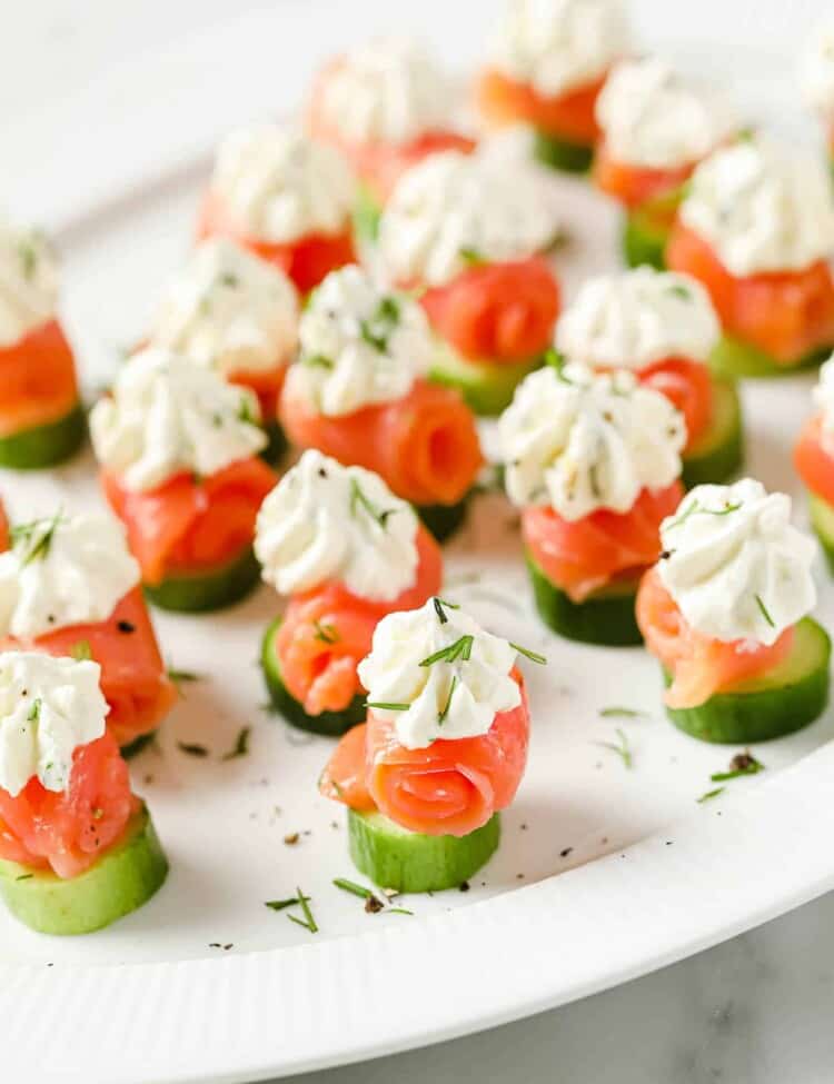 smoked salmon appetizer bites on a plate topped with lemon cream cheese