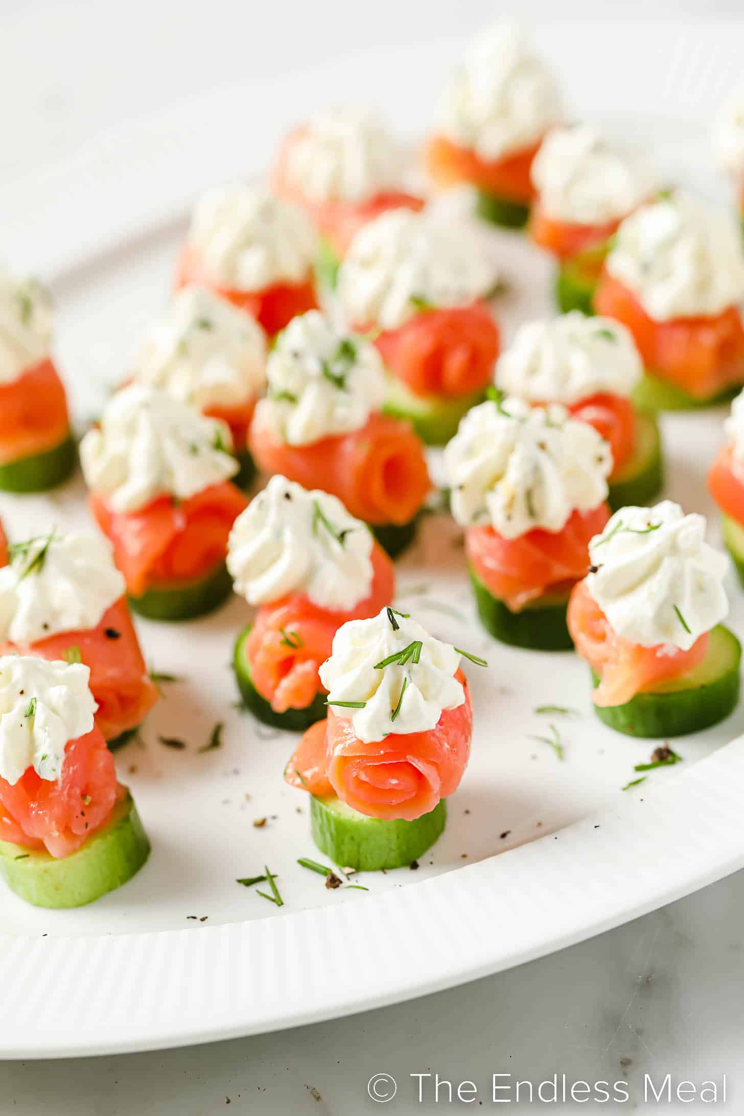 smoked salmon appetizer bites on a plate topped with lemon cream cheese