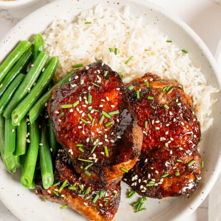 5 Spice Chicken with rice and beans on a plate