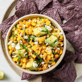 Mexican Corn Dip on a plate with corn chips