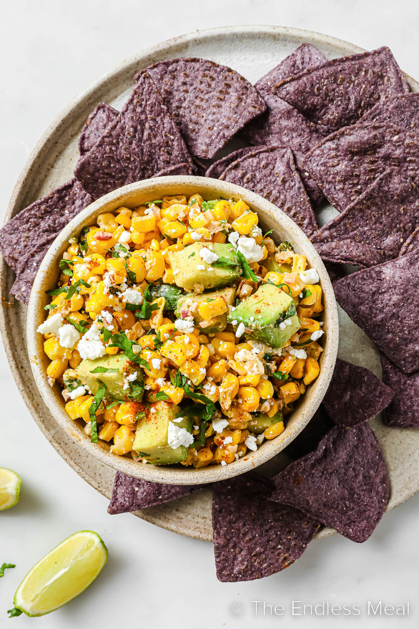 Mexican Corn Dip on a plate with corn chips