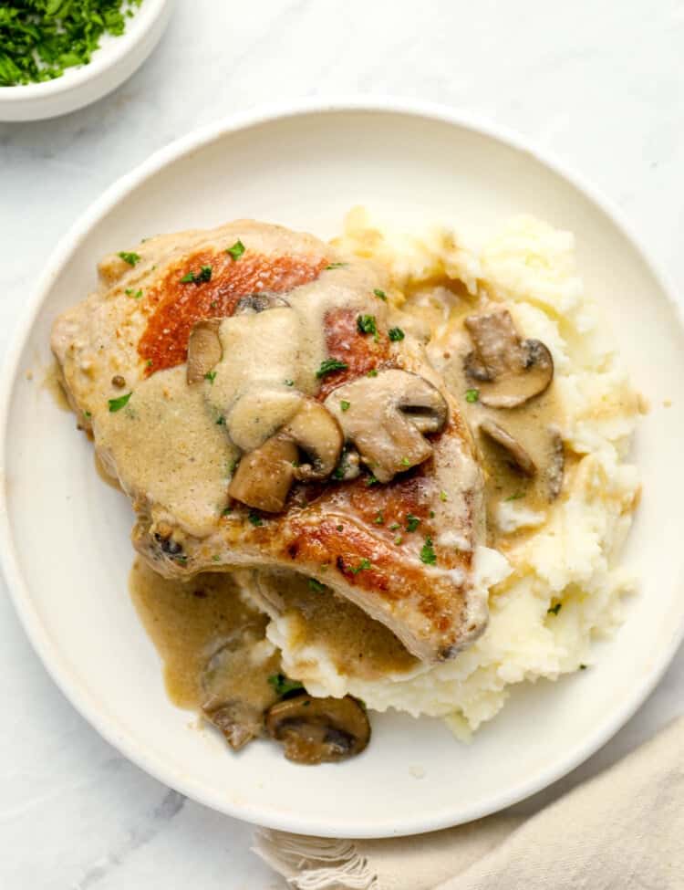 Cream of Mushroom Pork Chops on a dinner plate with mashed potatoes