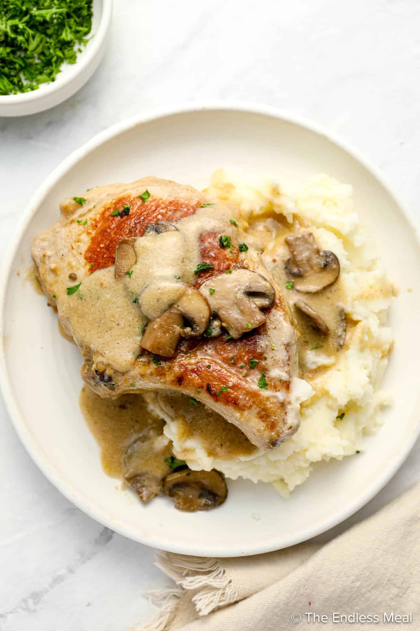 Cream of Mushroom Pork Chops on a dinner plate with mashed potatoes