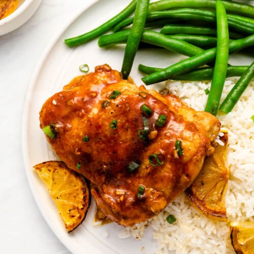 Honey Lemon Chicken on a dinner plate with rice and green beans