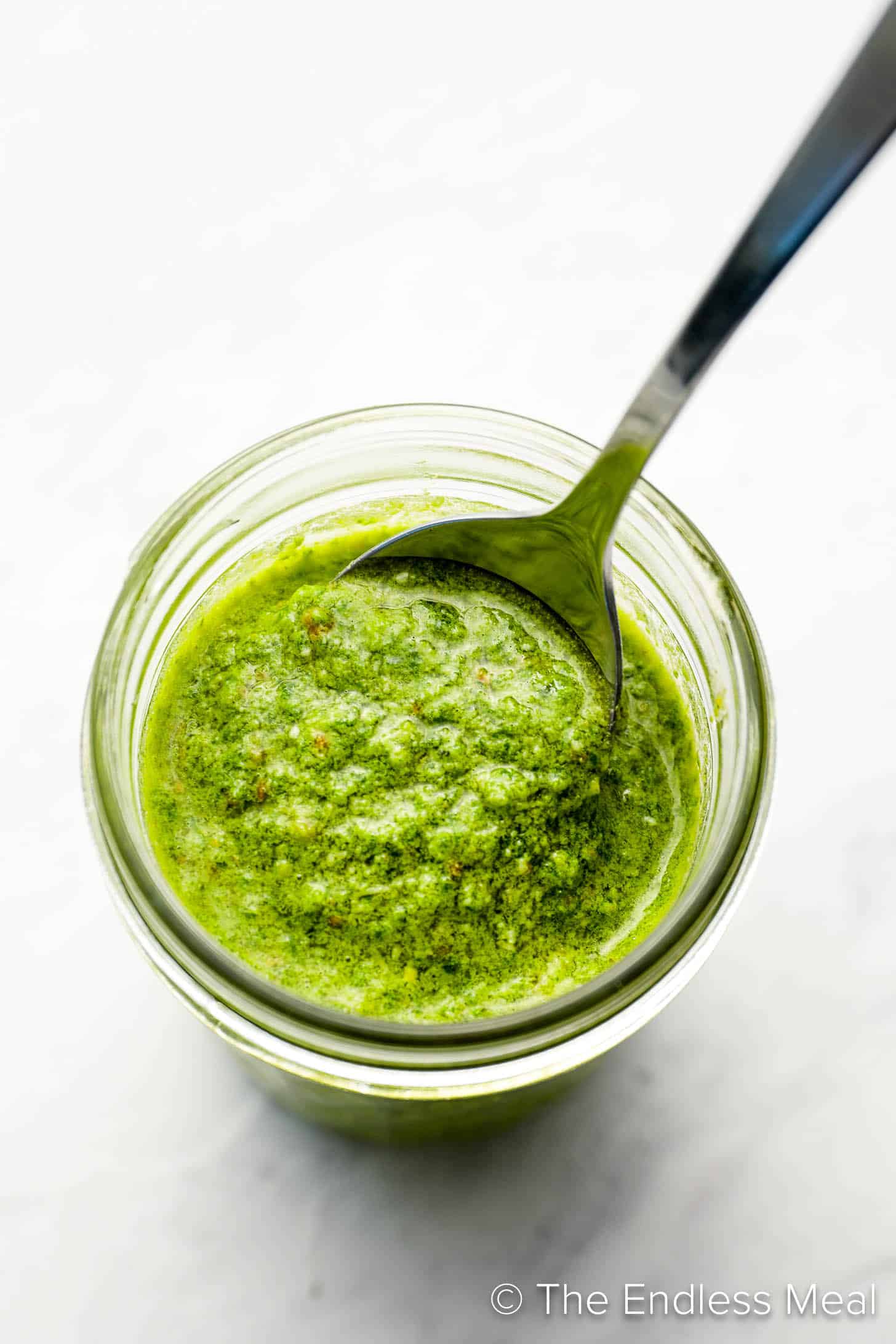 This Easy Pesto Recipe in a jar with a spoon