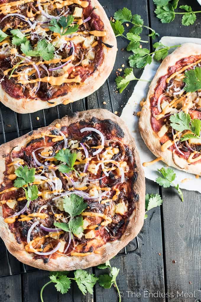Gochujang Pulled Pork Korean Pizza is a remake of the classic ham and pineapple pizza and WAY BETTER than the original. It's served with an easy to make kimchi dipping sauce and is crazy delicious. | theendlessmeal.com