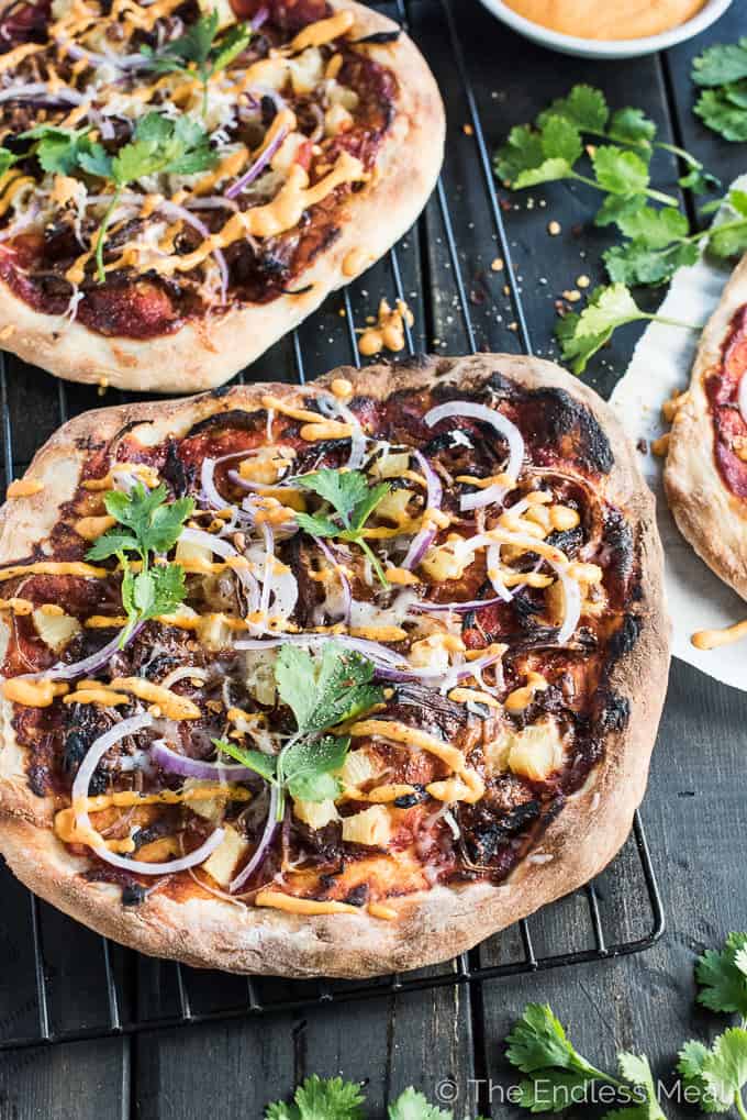 Gochujang Pulled Pork Korean Pizza is a remake of the classic ham and pineapple pizza and WAY BETTER than the original. It's served with an easy to make kimchi dipping sauce and is crazy delicious. | theendlessmeal.com