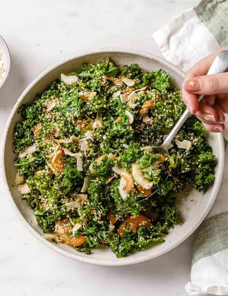 Coconut Sesame Kale Salad in a bowl with a fork