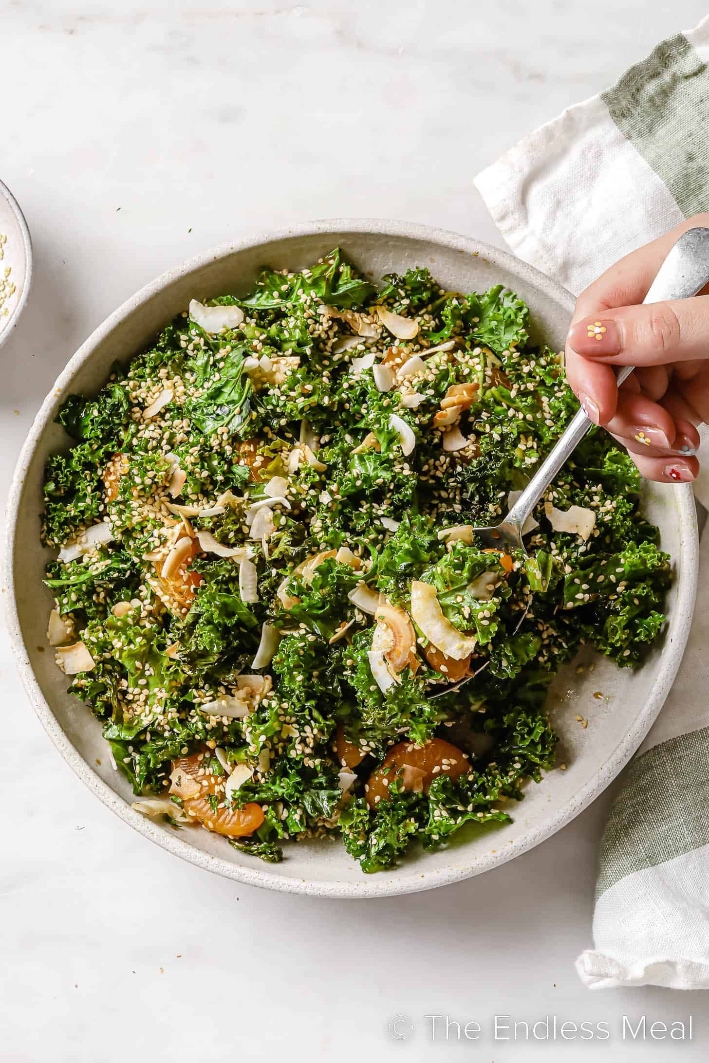 Coconut Sesame Kale Salad in a bowl with a fork