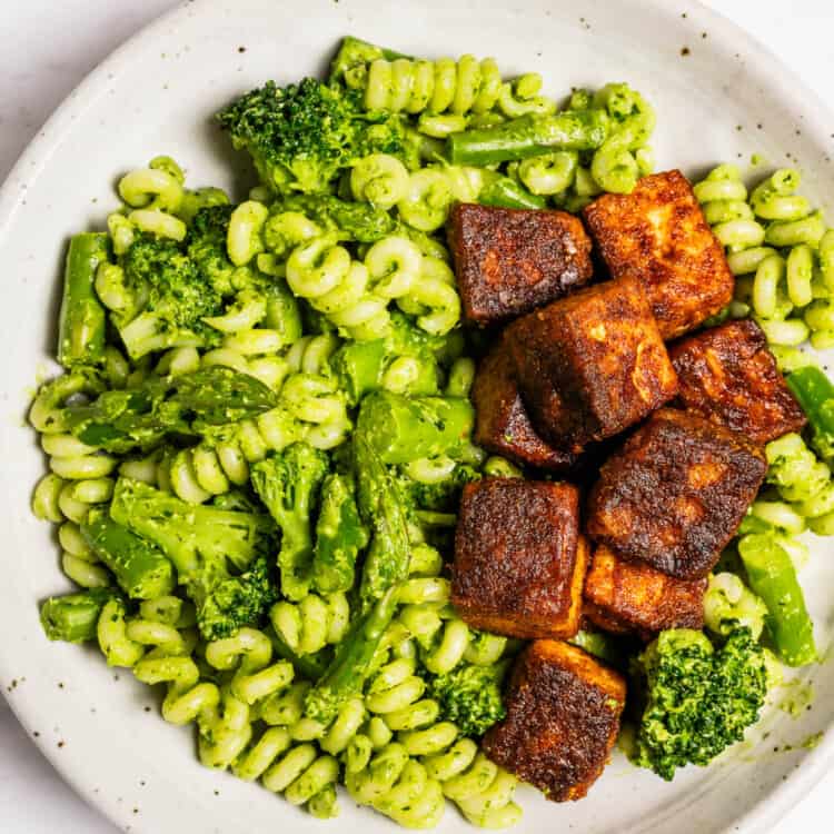 Green Pasta with crispy tofu in a dinner bowl.
