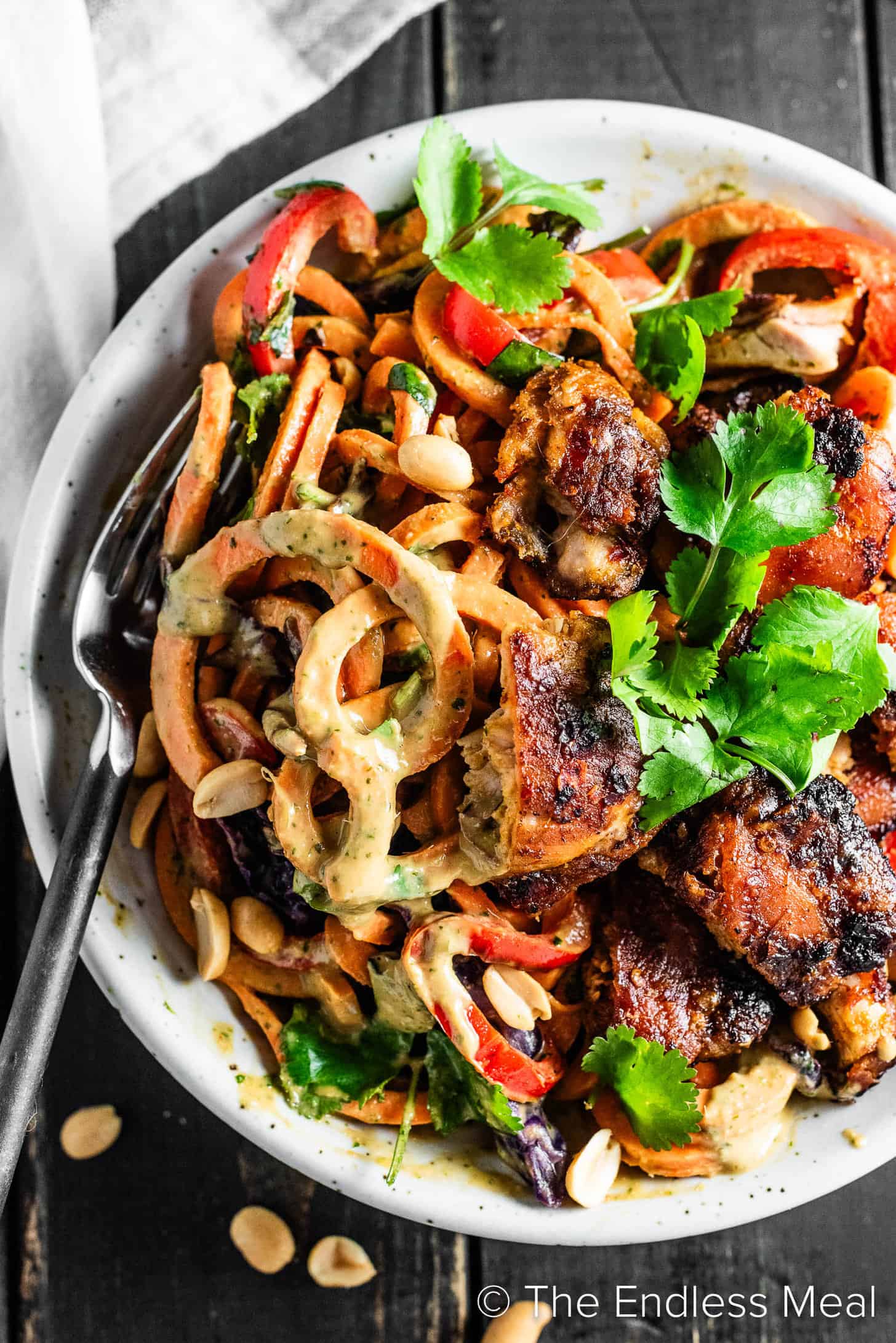 Sweet Potato Noodle Stir Fry with chicken in a dinner bowl.