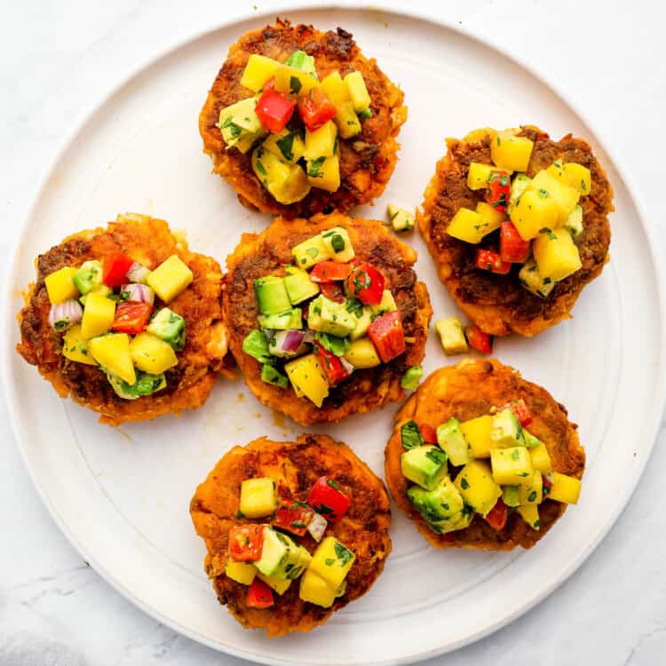 Thai Fish Cakes on a plate topped with mango salsa