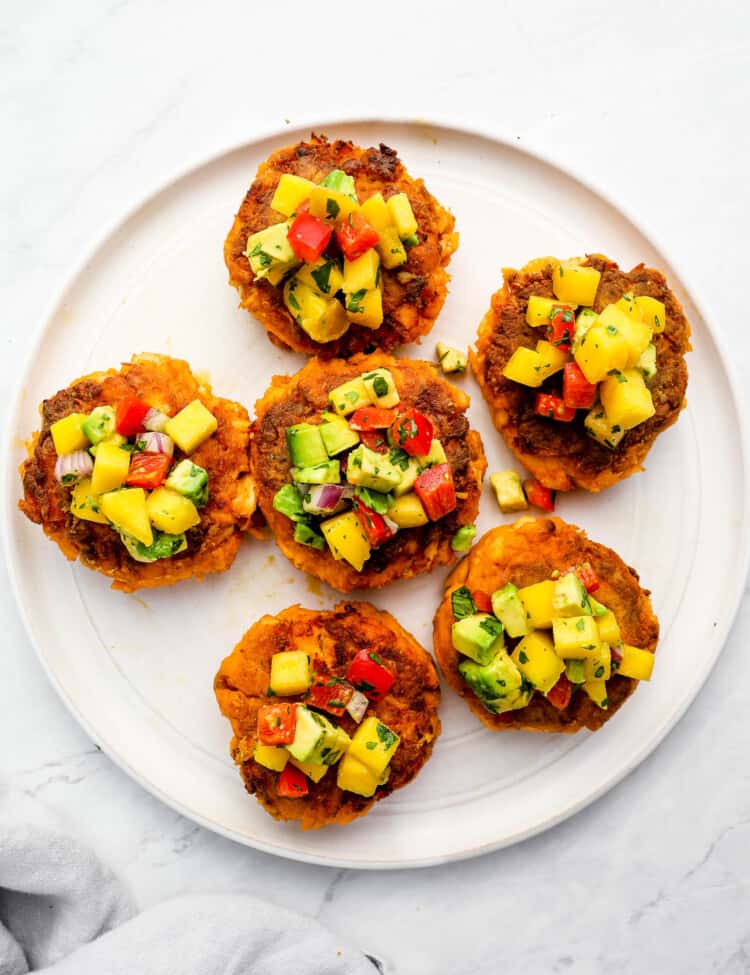 Thai Fish Cakes on a plate topped with mango salsa