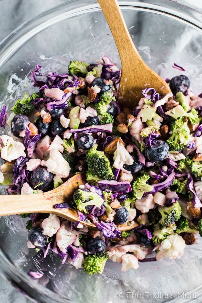 This easy to make Broccoli Cauliflower Blueberry Coleslaw is dotted with sweet blueberries (fresh or frozen!) and crunchy chopped almonds. It's a delicious and healthy side dish recipe that is gluten-free + paleo + Whole30 and can easily be made vegan.
