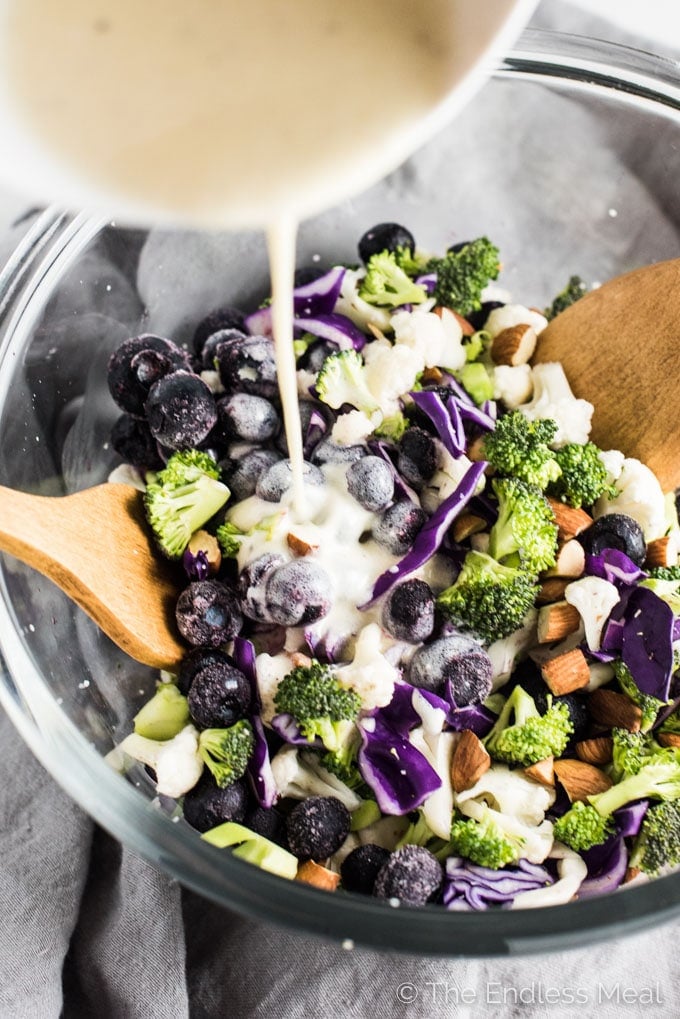 This easy to make Broccoli Cauliflower Blueberry Coleslaw is dotted with sweet blueberries (fresh or frozen!) and crunchy chopped almonds. It's a delicious and healthy side dish recipe that is gluten-free + paleo + Whole30 and can easily be made vegan.