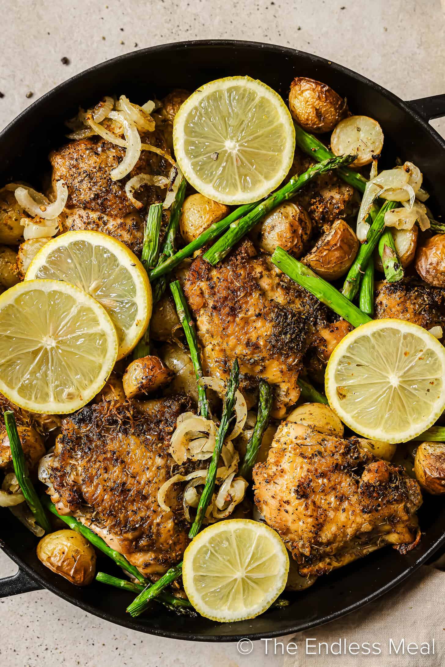 Greek Lemon Chicken and Potatoes cooking in a pan