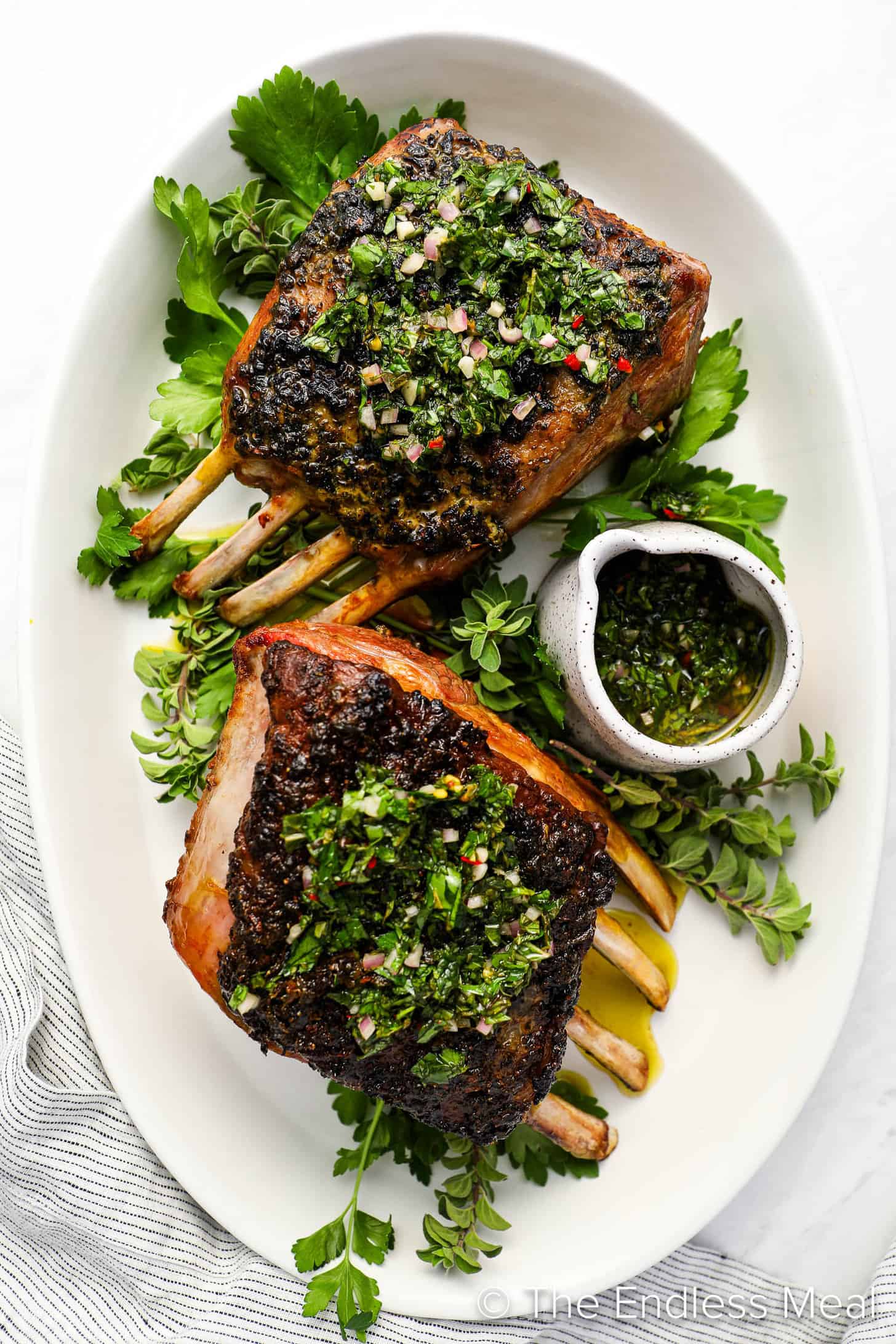 Roasted Rack of Lamb with mint chimichurri on a serving platter