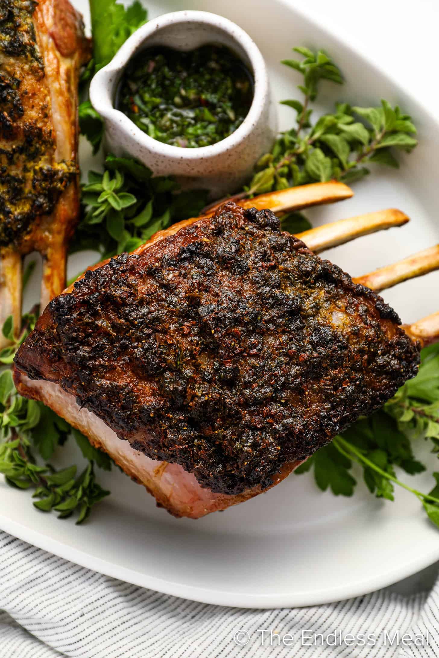 A close up of Roasted Rack of Lamb on a dinner serving platter