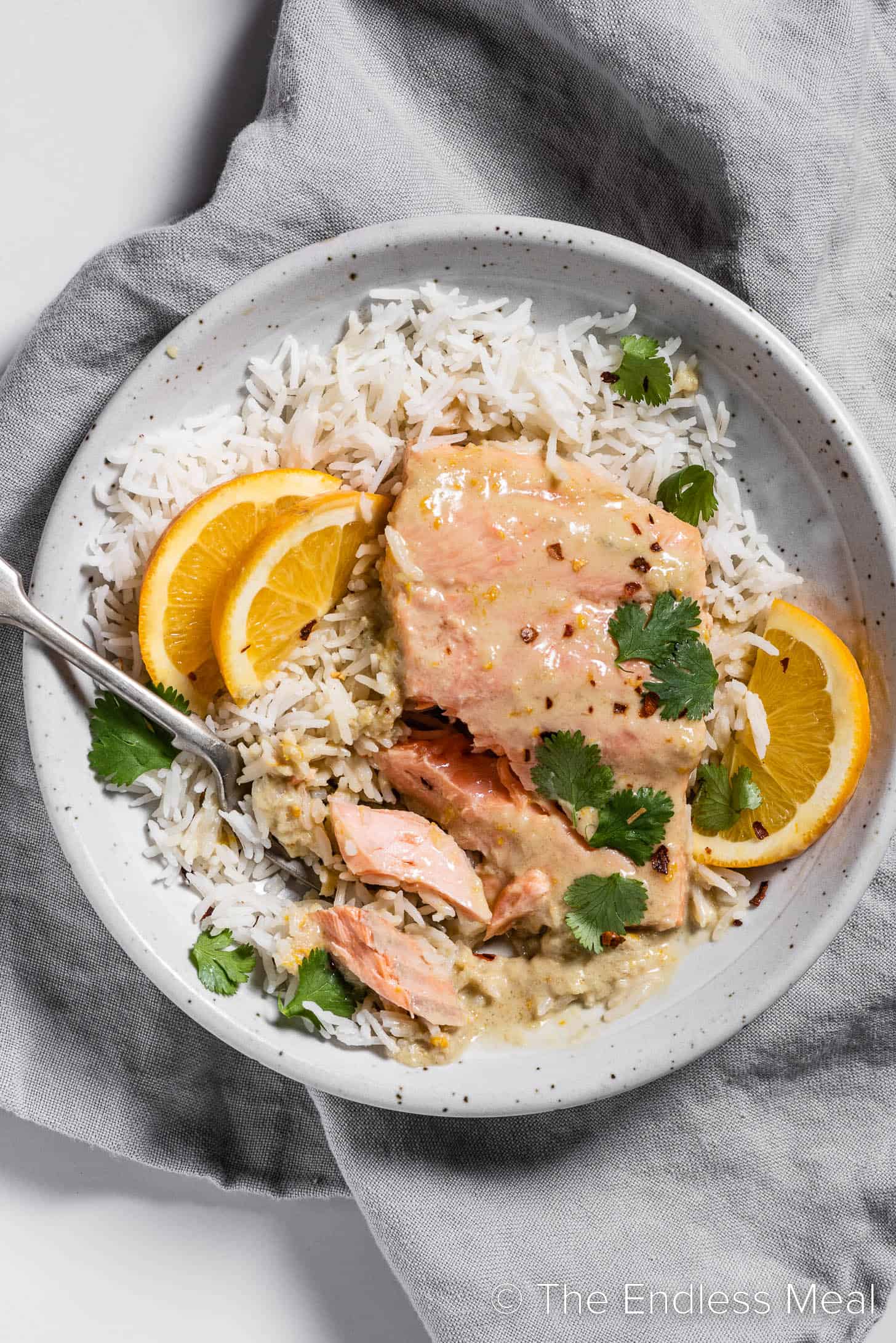 A bowl of Coconut Orange Poached Salmon with rice.