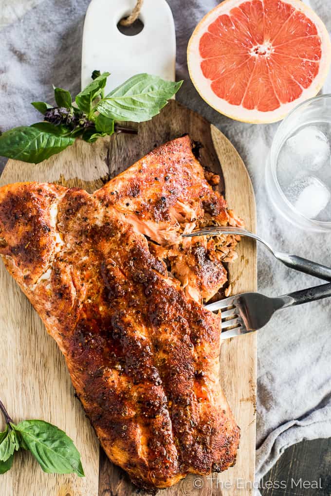 This fresh and tropical Grilled Salmon Salad is as delicious as it gets. Toss your favorite spring greens in a grapefruit coconut salad dressing and top with bites of grapefruit, chopped almonds, a little dill, and spicy grilled salmon. It's a healthy lunch or dinner recipe that is gluten-free + paleo + Whole30 approved. | theendlessmeal.com