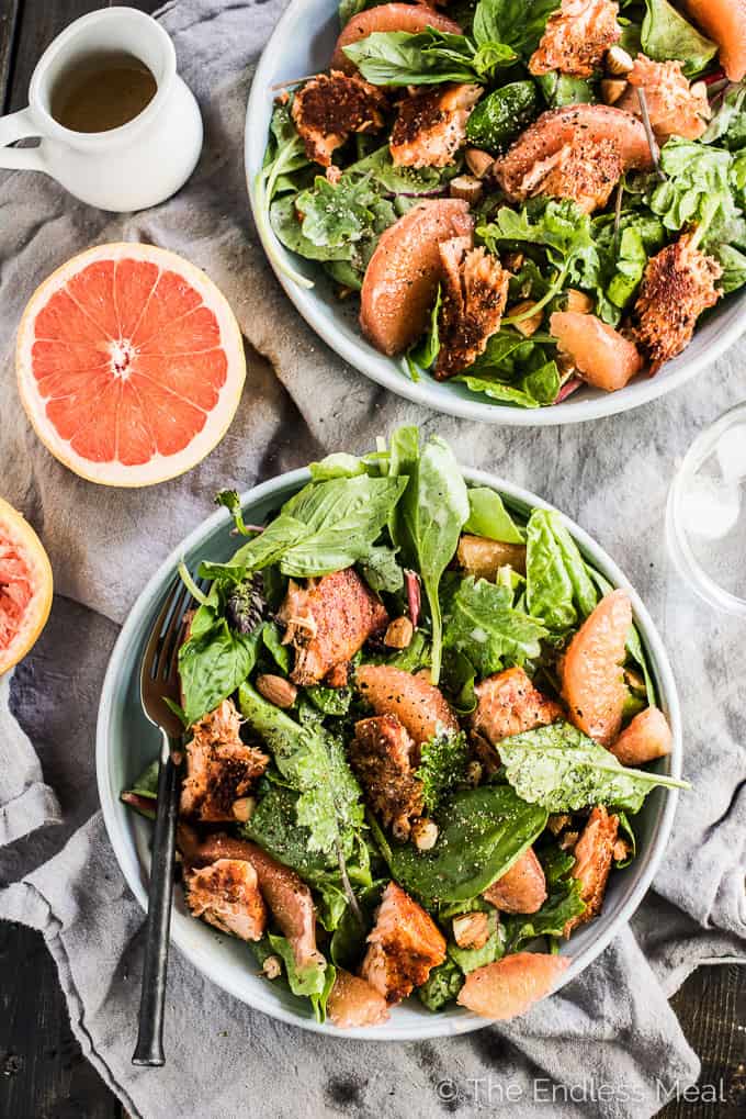 This fresh and tropical Grilled Salmon Salad is as delicious as it gets. Toss your favorite spring greens in a grapefruit coconut salad dressing and top with bites of grapefruit, chopped almonds, a little dill, and spicy grilled salmon. It's a healthy lunch or dinner recipe that is gluten-free + paleo + Whole30 approved. | theendlessmeal.com