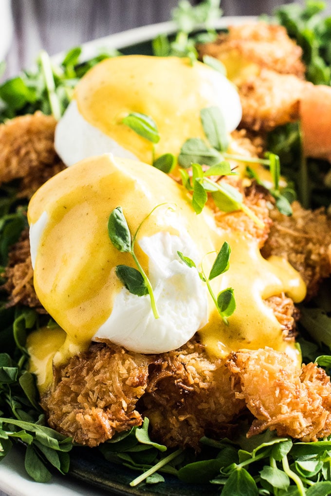 I'm fairly certain that Thai Coconut Shrimp Eggs Benedict is the only eggs benny I'll ever eat again. Perfectly poached eggs sit on top of crispy baked coconut shrimp and are smothered in a lightly flavored Thai curry hollandaise sauce. This insanely delicious breakfast recipe also happens to be healthy for you. (Crazy, I know!) It's naturally gluten-free + paleo + Whole30 compliant. You will LOVE it! | theendlessmeal.com