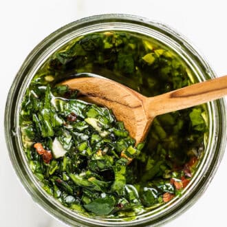 this Chimichurri Sauce Recipe in a jar with a wooden spoon