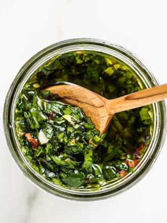 this Chimichurri Sauce Recipe in a jar with a wooden spoon