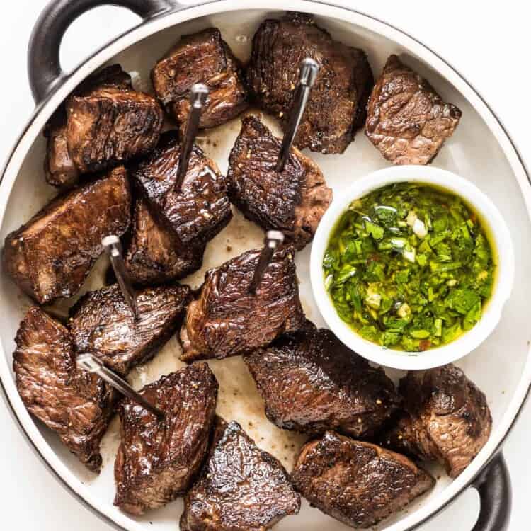steak bites with a side of chimichurri sauce