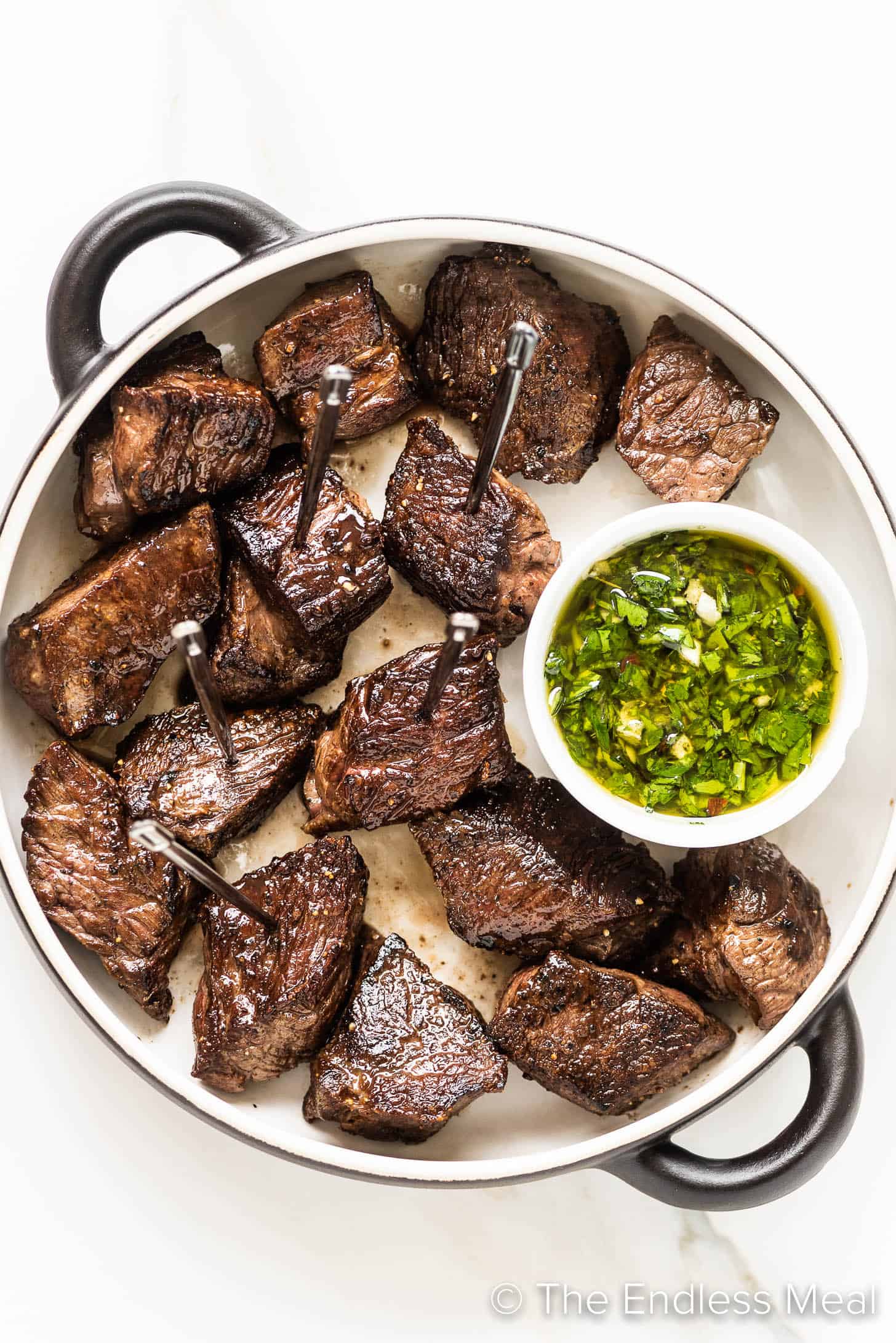 steak bites with a side of chimichurri sauce