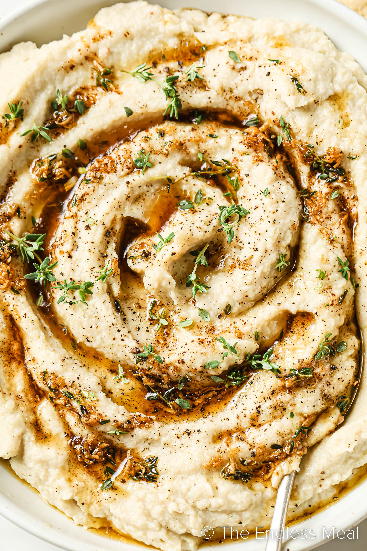 a close up of Brown Butter Mashed Cauliflower in a bowl