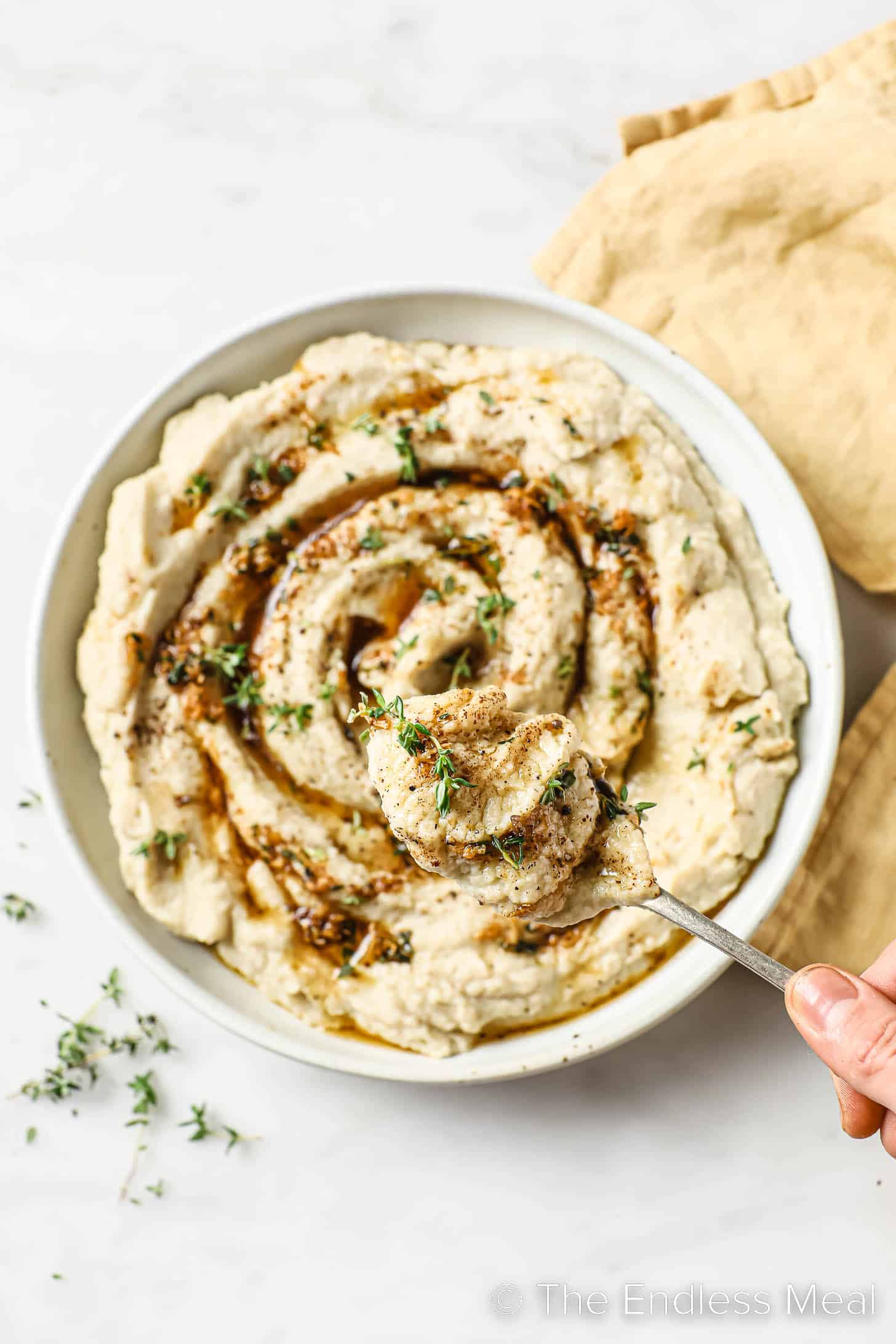 someone serving cauliflower mash with brown butter