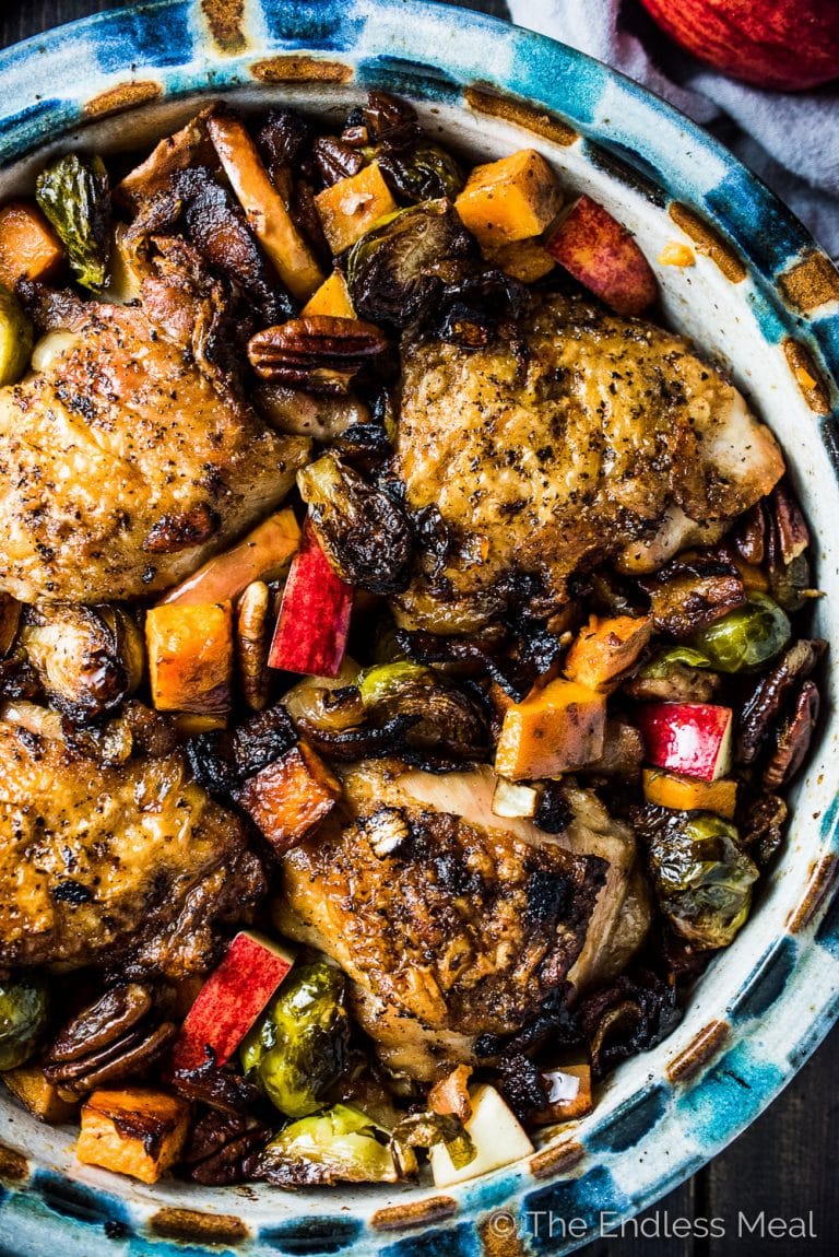 This delicious Bacon Apple Chicken is the perfect fall dinner recipe. The bacon and chicken are crisped on your stove top then everything gets nestled into a baking dish and roasted together. It's a healthy and easy to make recipe that is bursting with flavor. It's also gluten-free + paleo + Whole30 compliant.  | theendlessmeal.com