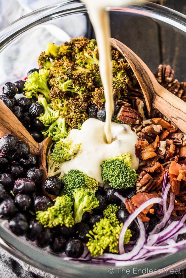 This deliciously Tangy Roasted Broccoli Salad is dotted with fresh or frozen blueberries, bacon, and pecans. It's the perfect healthy winter salad recipe. You will LOVE it! | theendlessmeal.com | #salad #saladrecipes #broccoli #broccolirecipes 