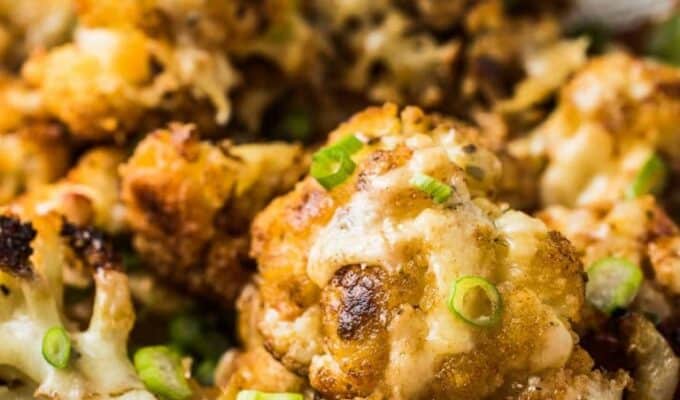 This insanely delicious Irish Cheddar Cauliflower is first tossed in spices and roasted in the oven. Then it's topped with Irish cheddar popped back in the oven until it melts. It's like cauliflower with cheese sauce only a thousand times better. | vegatarian + gluten-free | thendlessmeal.com | #cauliflowerrecipes #stpatricksday #irishrecipes #cauliflower #vegetarianrecipes #glutenfreerecipes