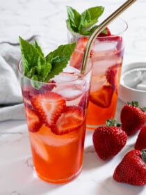 A Strawberry Mojito cocktail in a glass with a straw