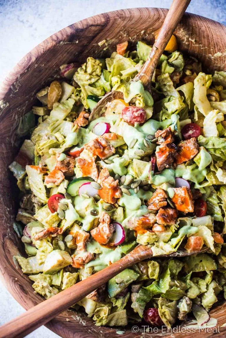 This delicious Buffalo Chicken Salad is loaded with crispy romaine hearts, spicy buffalo chicken, all your favorite veggies and tossed in a healthy and super tasty avocado ranch dressing. We like it as a hearty dinner salad but it's just as good as a part of a bigger BBQ meal.  | gluten-free + paleo + Whole30 adaptable | #theendlessmeal #chicken #salad #buffalochicken #ranch #whole30 #paleo #glutenfree #healthyrecipes