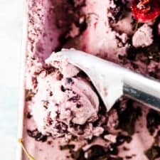 Coconut Cherry Ice Cream is dotted with fresh cherries and chunks of dark chocolate and can be made with or without an ice cream maker. And you'd NEVER guess it's made with healthy ingredients! | vegan + paleo + refined sugar-free | #theendlessmeal #icecream #veganicecream #paleo #cherries #coconut #coconuticecream #summer #nochurnicecream