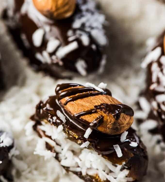 Almond Joy Stuffed Dates are the ultimate healthy treat. The dates are stuffed with coconut then dipped in chocolate and topped with an almond and a sprinkle of sea salt.  | vegan + paleo + gluten-free + refined sugar-free | #theendlessmeal #almondjoy #dates #paleo #vegan #coconut #stuffeddates #almond #dessert