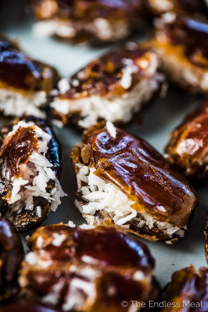 Almond Joy Stuffed Dates are the ultimate healthy treat. The dates are stuffed with coconut then dipped in chocolate and topped with an almond and a sprinkle of sea salt.  | vegan + paleo + gluten-free + refined sugar-free | #theendlessmeal #almondjoy #dates #paleo #vegan #coconut #stuffeddates #almond #dessert