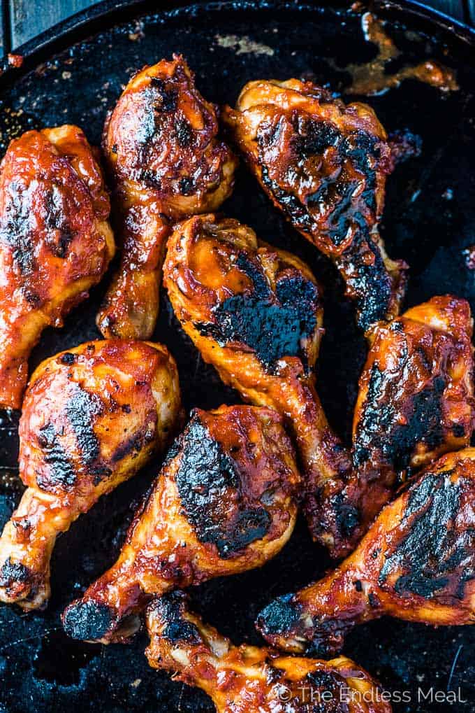 SAVE FOR LATER! Korean BBQ Chicken is smothered in an easy to make and DELICIOUS gochujang BBQ sauce then grilled until charred and crispy. This recipe will be your new summer favorite! | dairy-free + easily paleo + gluten-free | #theendlessmeal #chicken #koreanchicken #bbqchicken #gochujang #bbq #barbecue #paleo #glutenfree #dairyfree #summer #korean