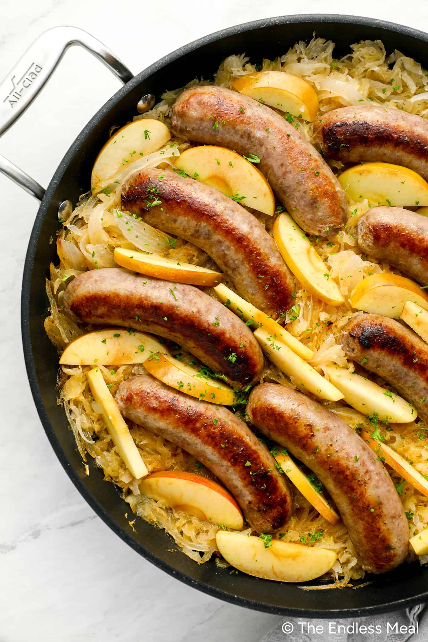 A close up of making Bratwurst and Sauerkraut in a pan