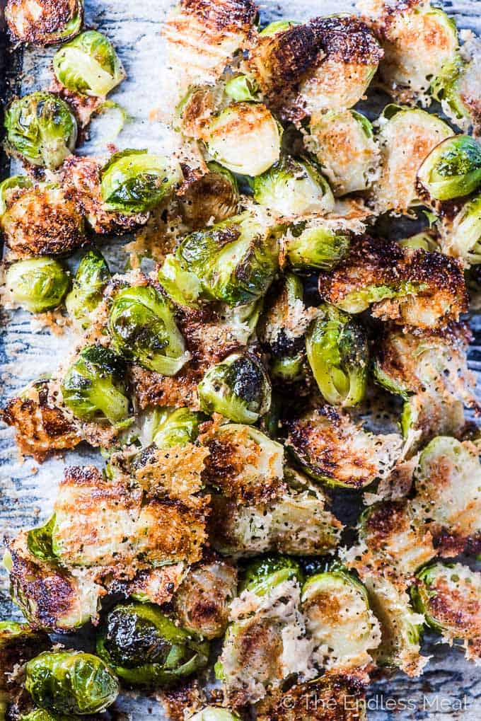 Parmesan brussels sprouts on a baking sheet all pulled apart from each other. 