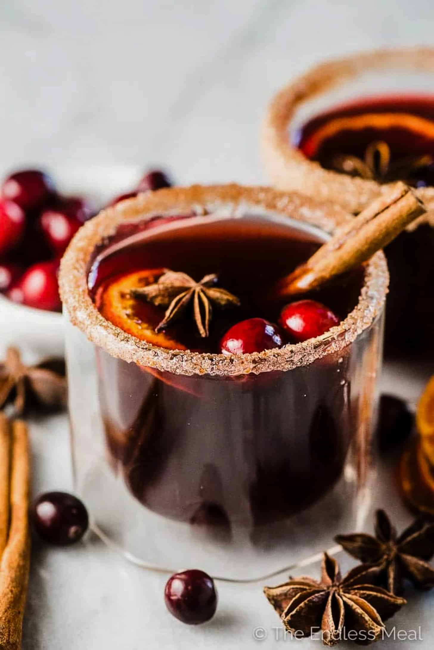 Cranberry Hot Toddy in a glass with a cinnamon stick
