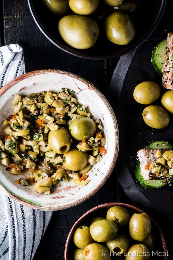 A bowl of Spanish manzanilla olive tapenade next to seared tuna bites. 
