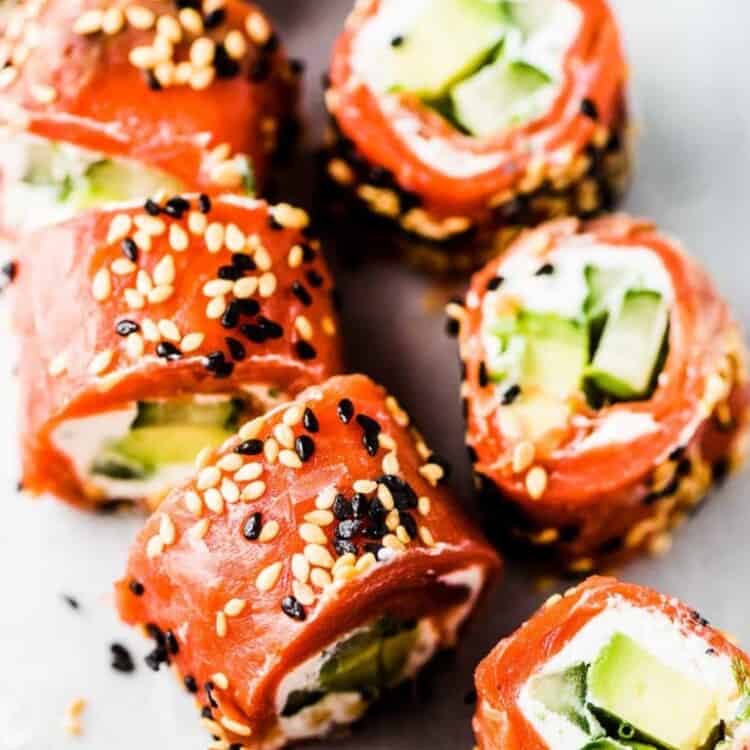 Slices of the Tzatziki Avocado Salmon Rolls on a marble tabletop.