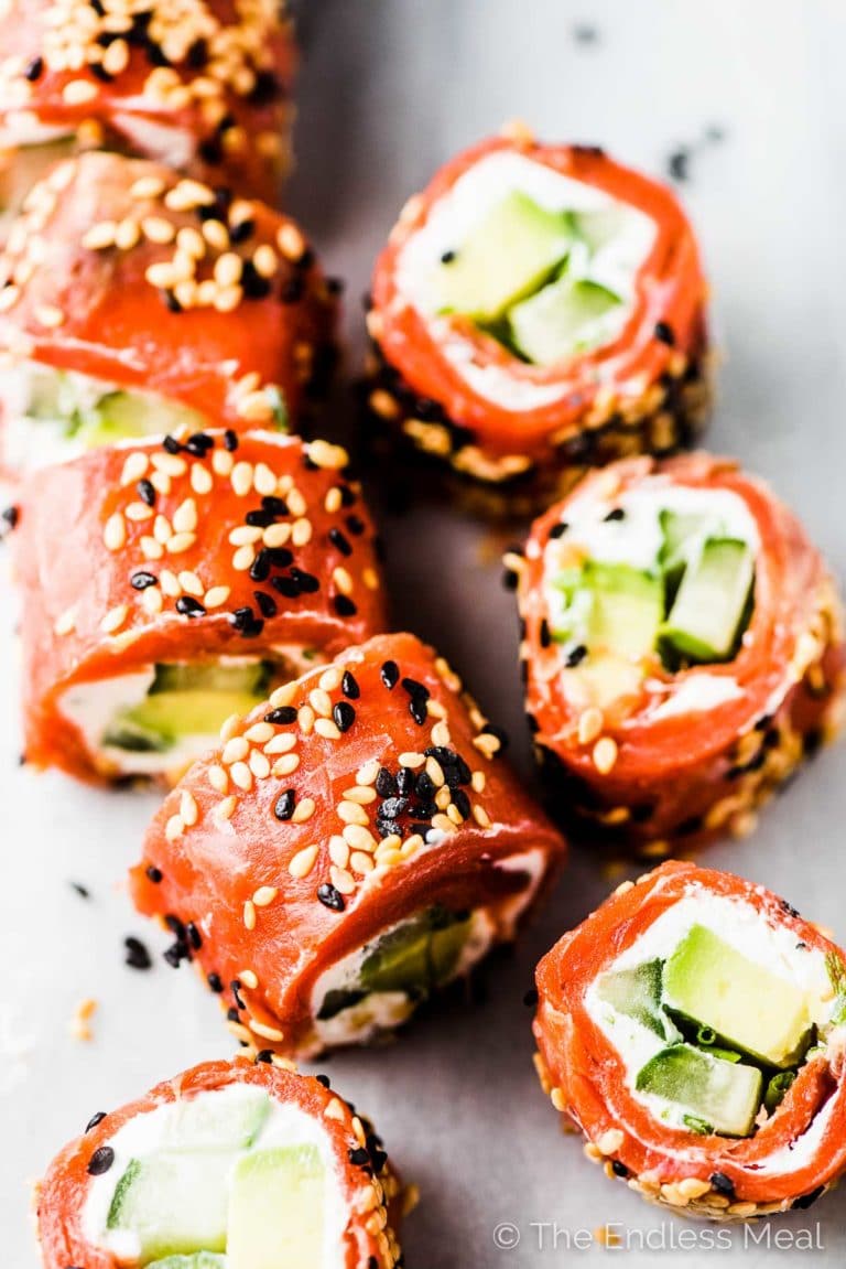 Slices of the Tzatziki Avocado Salmon Rolls on a marble tabletop. 