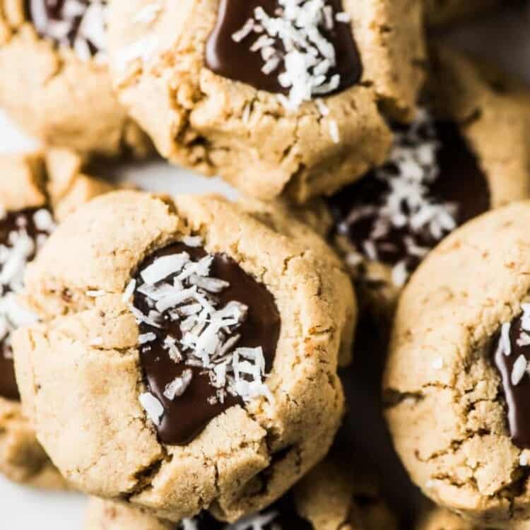 A closeup of a plate of Chocolate Almond Thumbprint Cookies.