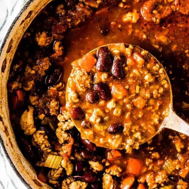 A pot of easy turkey chili with a ladle in it.