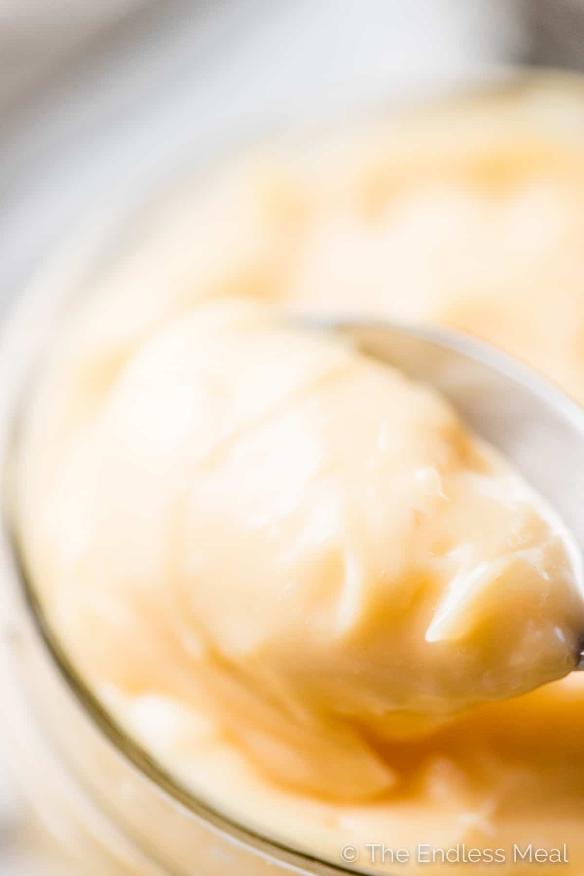 A close up of a spoonful of this homemade mayonnaise recipe.